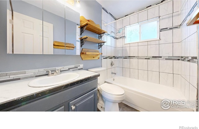 full bathroom with toilet, vanity, and tub / shower combination