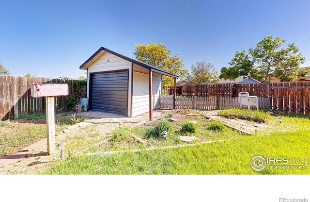detached garage featuring fence