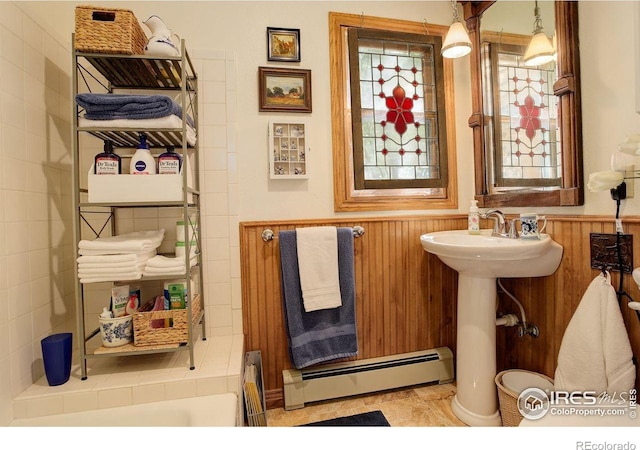 2219 Meadow Green Cir, Franktown, CO 80116 - bathroom featuring a baseboard radiator, wainscoting, and a sink