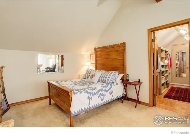 2219 Meadow Green Cir, Franktown, CO 80116 - bedroom featuring vaulted ceiling, baseboards, and carpet