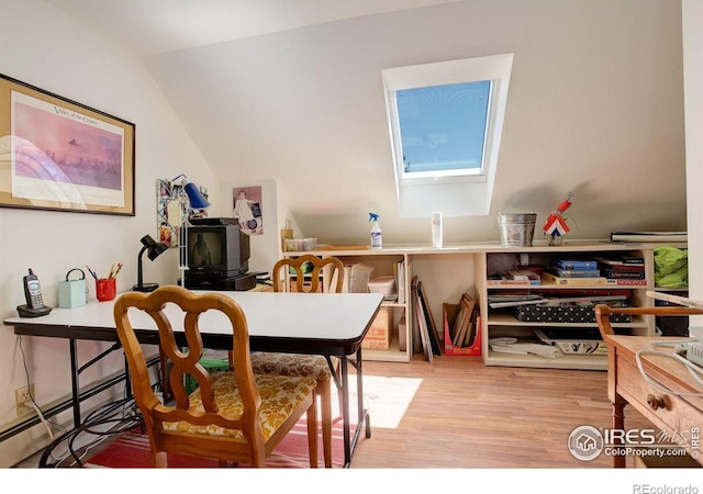 2219 Meadow Green Cir, Franktown, CO 80116 - dining space with light wood-type flooring, a skylight, and vaulted ceiling