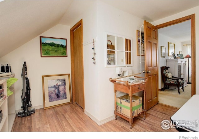 2219 Meadow Green Cir, Franktown, CO 80116 - corridor with light wood-style floors, lofted ceiling, and baseboards