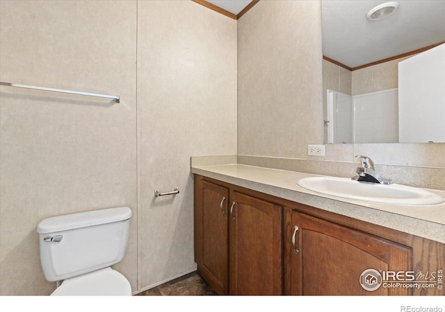 830 1st St # 14, Pierce, CO 80650 - bathroom featuring crown molding, vanity, and toilet