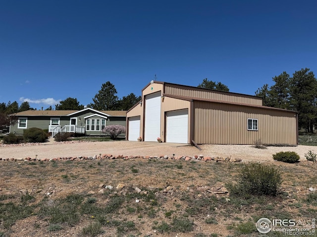 view of front of house featuring a garage and an outdoor structure
