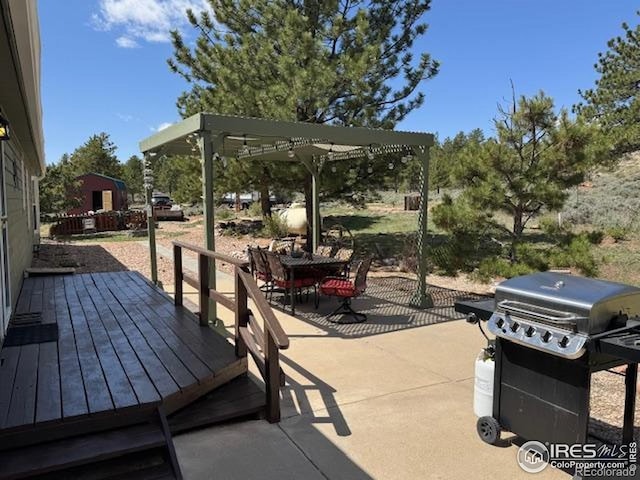 view of patio / terrace featuring area for grilling, outdoor dining area, and a wooden deck