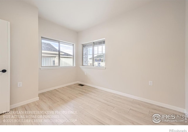 empty room with wood finished floors and baseboards