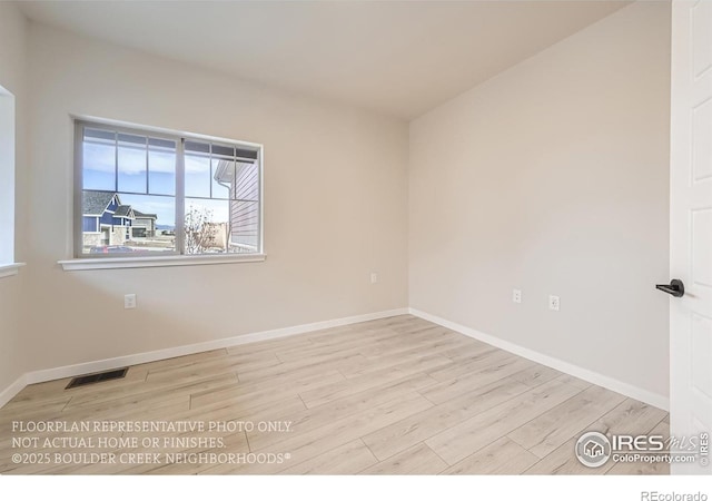 empty room with wood finished floors and baseboards