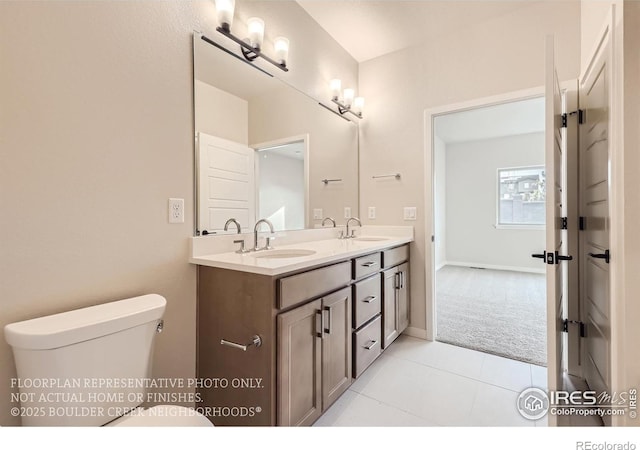 bathroom featuring double vanity, tile patterned flooring, toilet, and baseboards