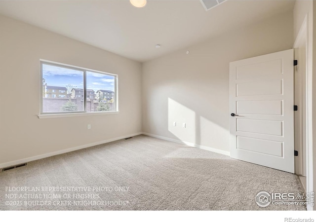 carpeted spare room featuring baseboards