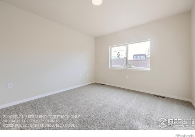 unfurnished room featuring carpet flooring and baseboards