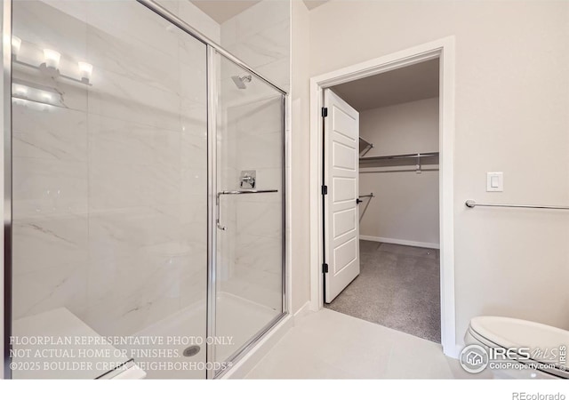 bathroom with a stall shower and a spacious closet