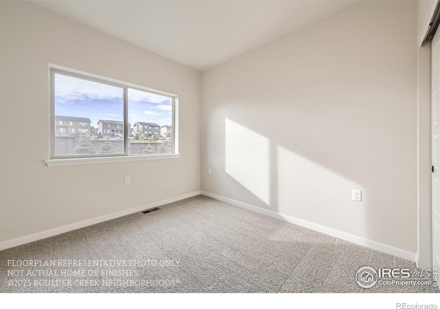 empty room with carpet and baseboards