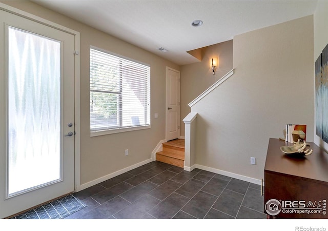2100 N Clay St, Denver, CO 80211 - entryway with stairway, dark tile patterned flooring, and baseboards