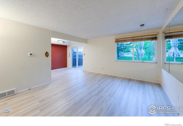 4140 Monroe Dr Unit C, Boulder, CO 80303 - unfurnished room with wood finished floors, healthy amount of natural light, a textured ceiling, and baseboards