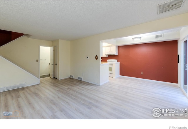 4140 Monroe Dr Unit C, Boulder, CO 80303 - unfurnished living room featuring light wood finished floors, a textured ceiling, and baseboards