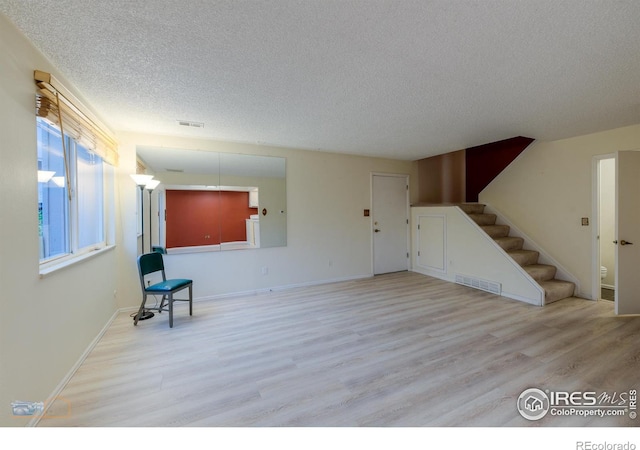 4140 Monroe Dr Unit C, Boulder, CO 80303 - unfurnished room featuring a textured ceiling, wood finished floors, stairs, and baseboards
