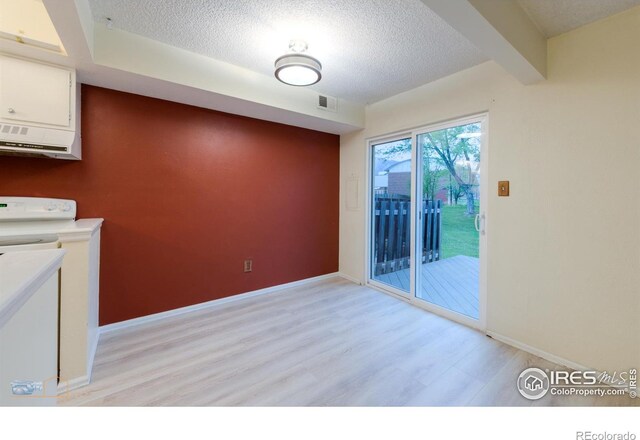 4140 Monroe Dr Unit C, Boulder, CO 80303 - unfurnished dining area with light wood-type flooring, a textured ceiling, baseboards, and washer / dryer
