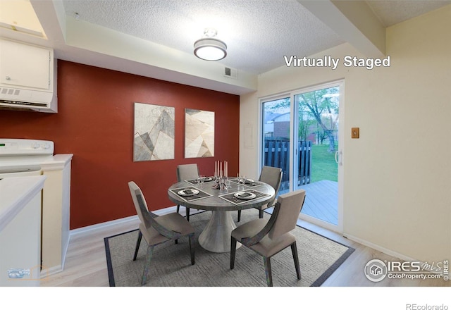 4140 Monroe Dr Unit C, Boulder, CO 80303 - dining room featuring light wood-style floors, a textured ceiling, and baseboards