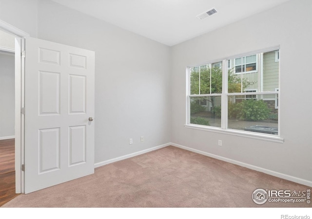 carpeted spare room with baseboards