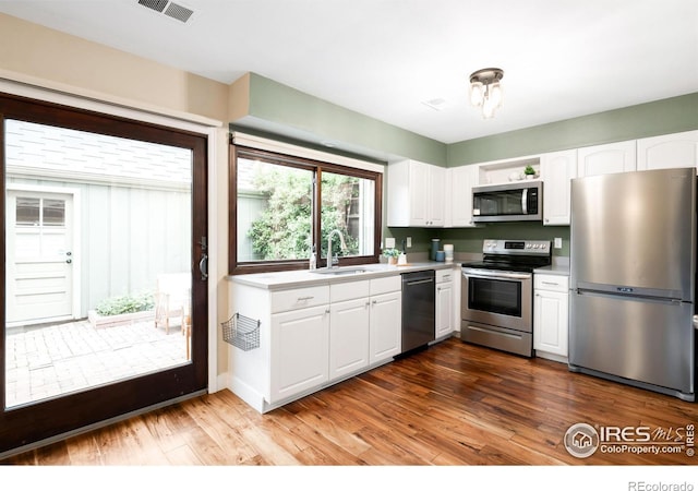 93 Benthaven Pl, Boulder, CO 80305 - kitchen with stainless steel appliances, a sink, light countertops, and white cabinets