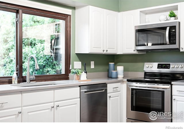 93 Benthaven Pl, Boulder, CO 80305 - kitchen with stainless steel appliances, a sink, healthy amount of natural light, and white cabinetry