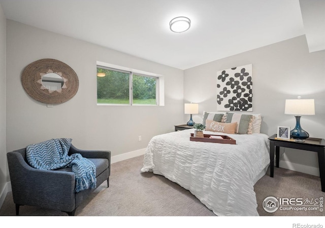 carpeted bedroom featuring baseboards