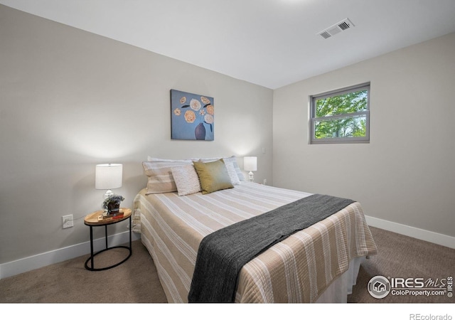 carpeted bedroom featuring baseboards