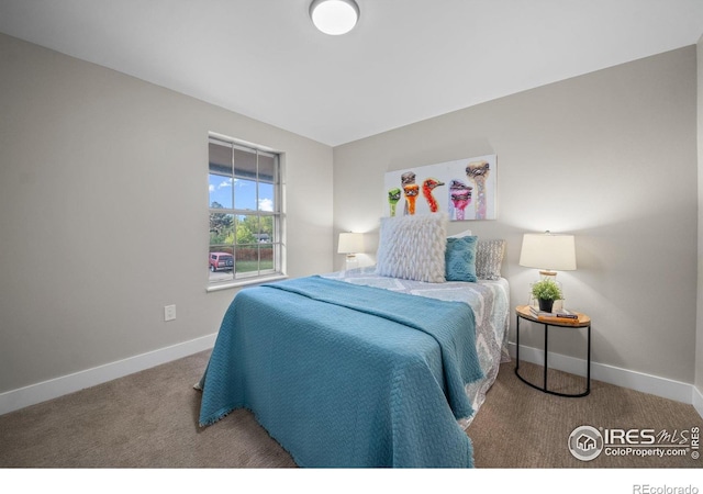 bedroom featuring carpet and baseboards