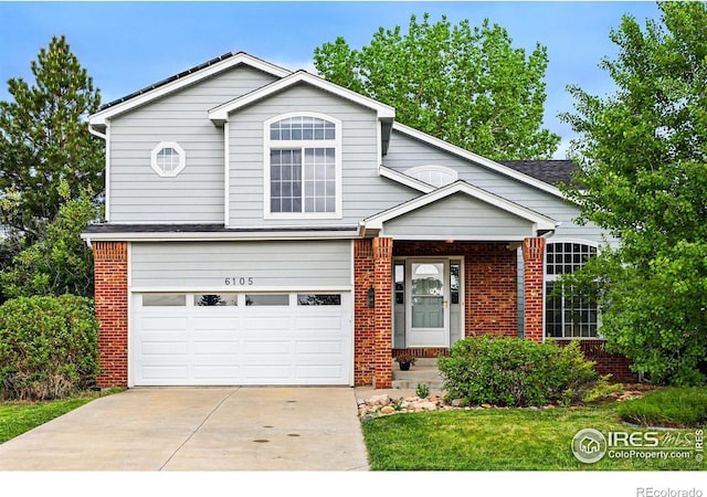 6105 El Diente Cir, Golden, CO 80403 - traditional home with brick siding, an attached garage, driveway, and a front yard