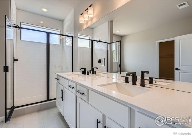 2710 Crystal Spgs, Longmont, CO 80503 - bathroom with double vanity, a stall shower, tile patterned flooring, and recessed lighting