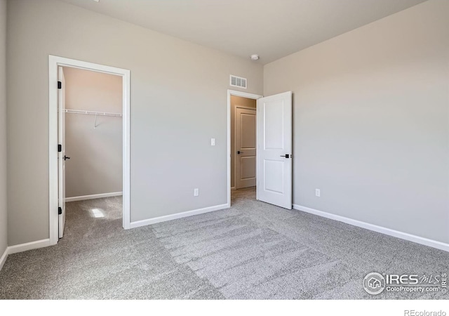 2710 Crystal Spgs, Longmont, CO 80503 - unfurnished bedroom with carpet flooring, a walk in closet, and a closet
