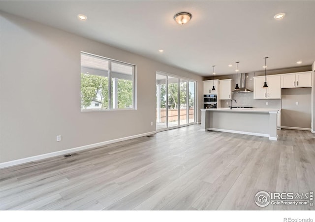 2710 Crystal Spgs, Longmont, CO 80503 - unfurnished living room featuring light wood finished floors and recessed lighting