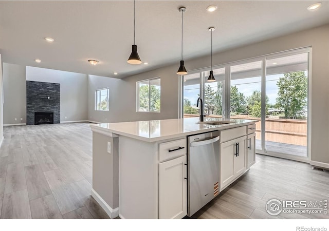 2710 Crystal Spgs, Longmont, CO 80503 - kitchen featuring stainless steel dishwasher, light wood finished floors, white cabinetry, light countertops, and recessed lighting