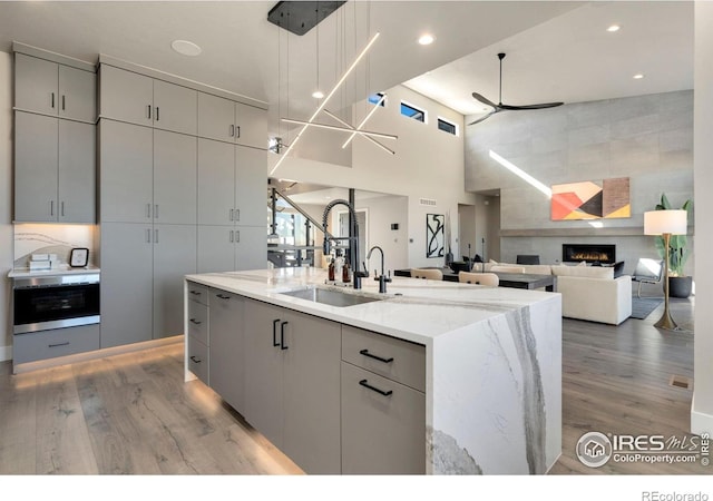 2123 Picture Point Dr, Windsor, CO 80550 - kitchen featuring a sink, gray cabinetry, a ceiling fan, light wood-type flooring, and recessed lighting