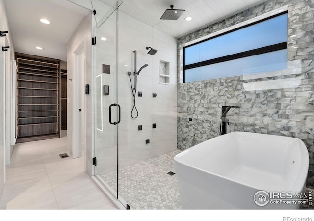 2123 Picture Point Dr, Windsor, CO 80550 - full bath with a stall shower, tile walls, a freestanding tub, tile patterned floors, and recessed lighting