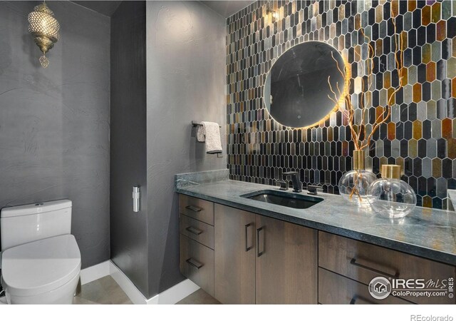 2123 Picture Point Dr, Windsor, CO 80550 - half bathroom with vanity, toilet, and baseboards