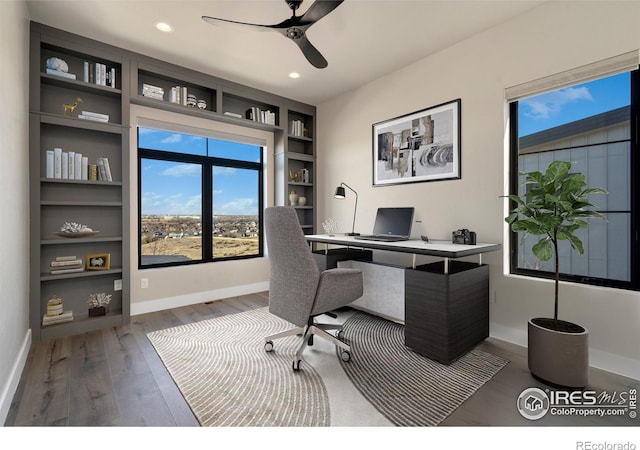 2123 Picture Point Dr, Windsor, CO 80550 - home office with plenty of natural light, wood finished floors, baseboards, ceiling fan, and recessed lighting