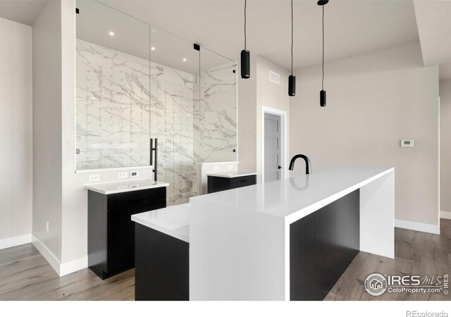 2123 Picture Point Dr, Windsor, CO 80550 - kitchen with wood finished floors, light countertops, baseboards, and recessed lighting