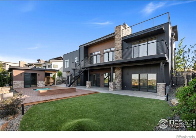 2123 Picture Point Dr, Windsor, CO 80550 - back of property featuring stone siding, a patio, a deck, a balcony, and stairs
