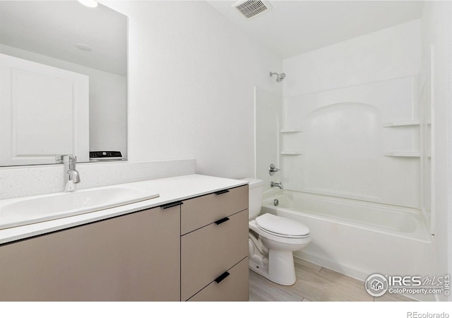 7864 5th St, Wellington, CO 80549 - bathroom with vanity, toilet, tub / shower combination, and wood finished floors