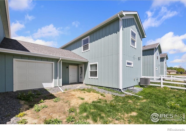 7864 5th St, Wellington, CO 80549 - view of front of home with fence, central air condition unit, and an attached garage