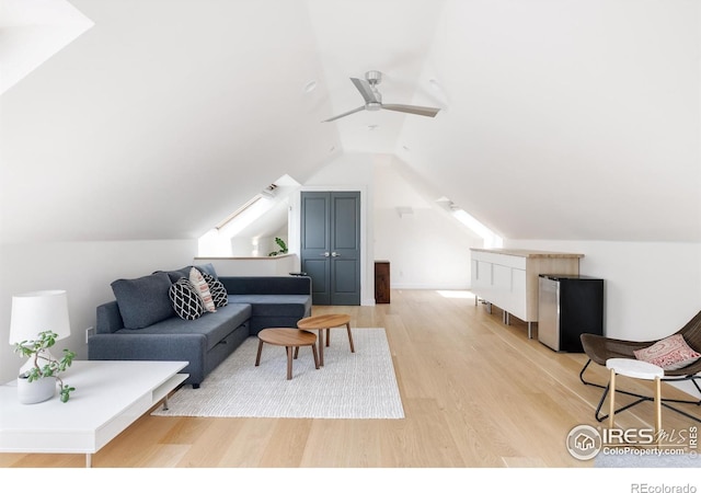 living area with light wood-type flooring, lofted ceiling, and ceiling fan