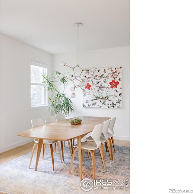 dining room with baseboards and light wood-style flooring