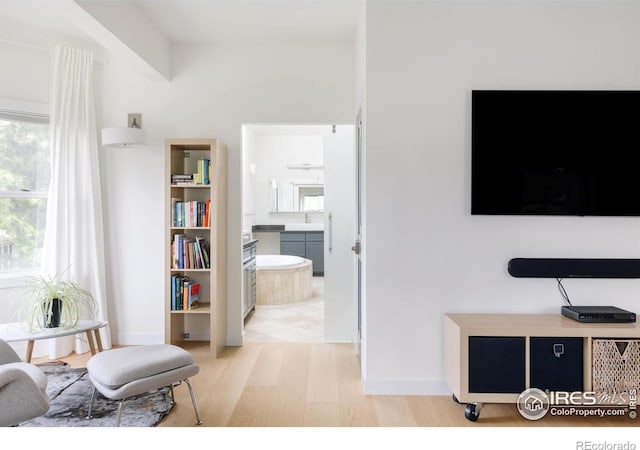 living area with light wood-style floors and baseboards