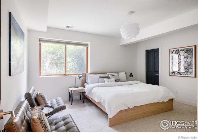 bedroom with carpet floors and baseboards