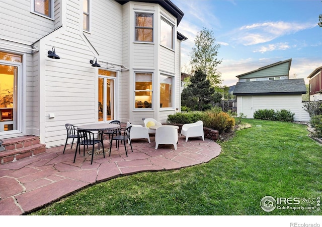 back of property featuring a patio area and a yard