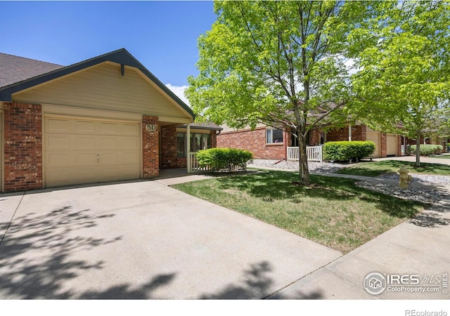 4560 Larkbunting Dr Unit 5D, Fort Collins, CO 80526 - view of front of home featuring brick siding, a garage, driveway, and a front yard