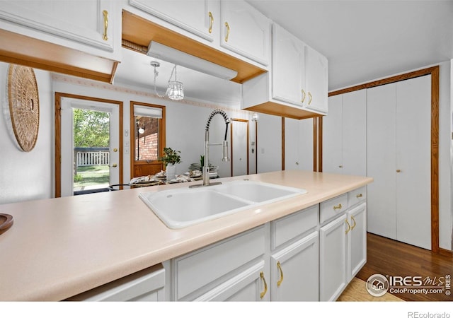 4560 Larkbunting Dr Unit 5D, Fort Collins, CO 80526 - kitchen with a sink, white cabinets, wood finished floors, and light countertops