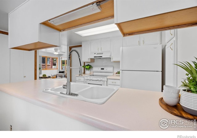 4560 Larkbunting Dr Unit 5D, Fort Collins, CO 80526 - kitchen with white appliances, a sink, under cabinet range hood, white cabinetry, and light countertops