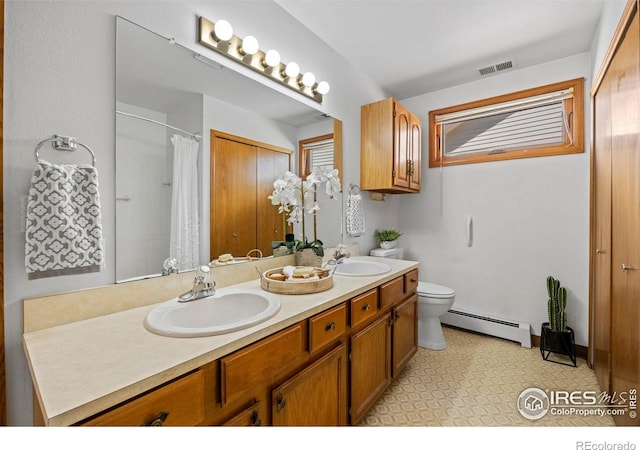 4560 Larkbunting Dr Unit 5D, Fort Collins, CO 80526 - bathroom featuring a baseboard heating unit, toilet, double vanity, and a shower with curtain